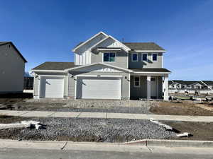 View of front facade with board and batten siding, a shingled roof, driveway, and a porch