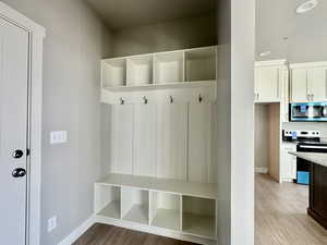 Mudroom featuring light wood finished floors and recessed lighting