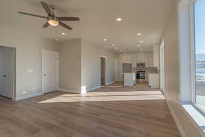 Unfurnished living room with recessed lighting, light wood-style floors, and a ceiling fan