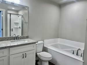 Bathroom featuring a bath, vanity, and a shower stall