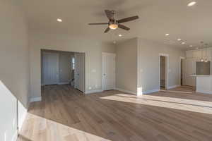 Unfurnished living room with light wood-type flooring, recessed lighting, and ceiling fan