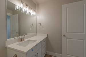 Bathroom featuring vanity and dark wood finished floors