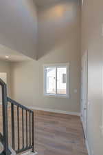 Entrance foyer featuring a high ceiling and light wood-style floors