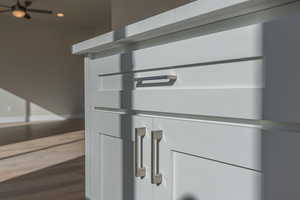 Detailed view of wood finished floors and recessed lighting