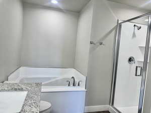 Bathroom featuring a stall shower and a bath