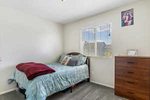 Bedroom featuring carpet flooring and baseboards