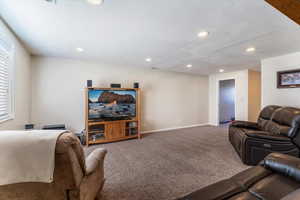 Carpeted living area featuring recessed lighting