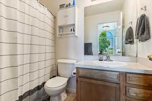Full bath with vanity, curtained shower, and light tile patterned floors