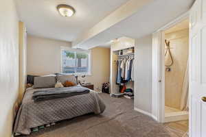 Carpeted bedroom featuring a closet and baseboards