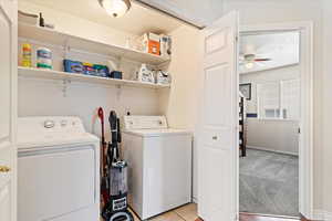 Laundry room with light tile patterned floors, and independent washer and dryer