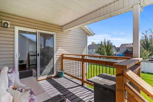 Deck featuring a yard and a residential view