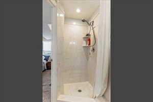Ensuite bathroom featuring a stall shower