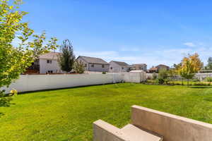 Fenced backyard featuring a residential view