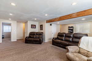 Living area featuring recessed lighting, carpet floors, and beam ceiling