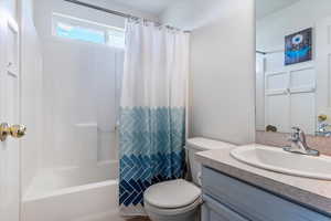 Bathroom with vanity and shower / tub combo