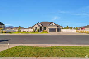 View of front of property with stone siding, concrete driveway, and a residential view