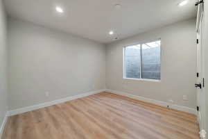 Spare room with recessed lighting and light wood-type flooring