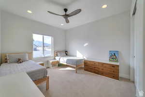 Carpeted bedroom featuring recessed lighting, a ceiling fan, and a mountain view