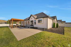 Back of house with a fenced backyard, a patio, roof with shingles, and stucco siding