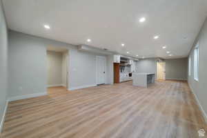 Unfurnished living room with light wood finished floors and recessed lighting