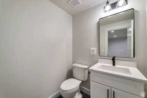 Bathroom featuring vanity and toilet