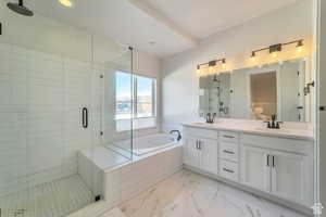 Bathroom with a shower stall, a garden tub, double vanity, recessed lighting, and light marble finish floors