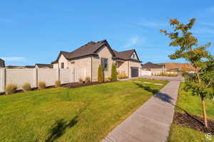 View of front of house featuring a garage, a residential view, and driveway