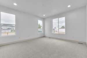 Unfurnished room featuring light colored carpet and recessed lighting