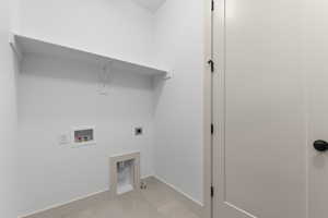 Laundry room featuring washer hookup, tile patterned floors, and electric dryer hookup