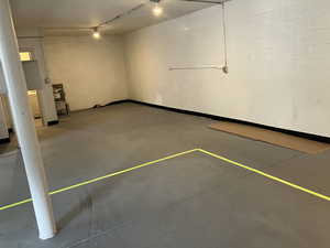 Garage featuring concrete block wall