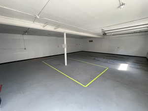 Garage featuring concrete block wall