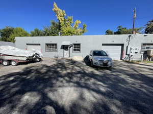 View of front facade with stucco siding, asphalt driveway, and an attached garage