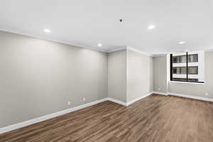 Unfurnished room featuring crown molding, wood finished floors, and recessed lighting