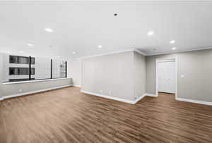 Unfurnished room featuring recessed lighting, wood finished floors, and ornamental molding