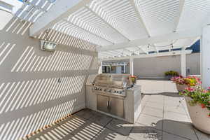 View of patio / terrace with a pergola and an outdoor kitchen