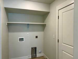 Laundry area featuring hookup for a washing machine, electric dryer hookup, and wood finished floors