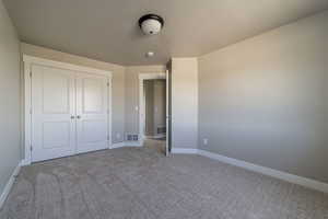 Unfurnished bedroom with carpet floors and a closet