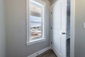 Entryway with baseboards and wood finished floors