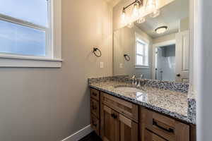 Bathroom featuring vanity and baseboards