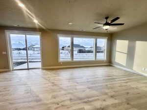 Spare room featuring recessed lighting, a textured ceiling, light wood-style flooring, and a ceiling fan