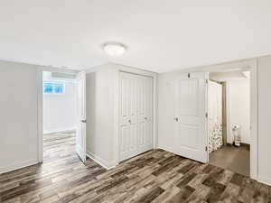 Unfurnished bedroom with a closet and wood finished floors