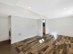 Finished below grade area with dark wood-type flooring and recessed lighting