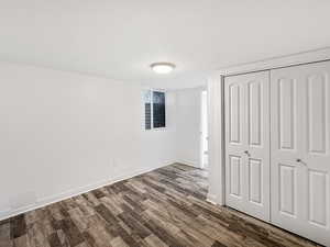 Unfurnished bedroom featuring a closet and wood finished floors