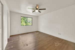 Unfurnished bedroom with wood finished floors and ceiling fan