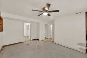 Unfurnished bedroom featuring a ceiling fan and a textured ceiling