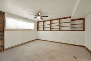 Unfurnished room featuring a textured ceiling and ceiling fan