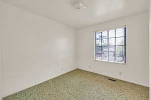 Empty room featuring baseboards