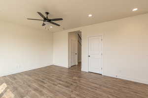 Unfurnished room featuring recessed lighting, dark wood-style flooring, and a ceiling fan