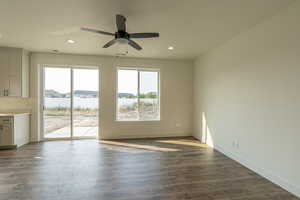 Empty room featuring plenty of natural light, dark wood-style floors, recessed lighting, and ceiling fan
