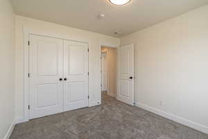 Unfurnished bedroom with carpet floors and a closet